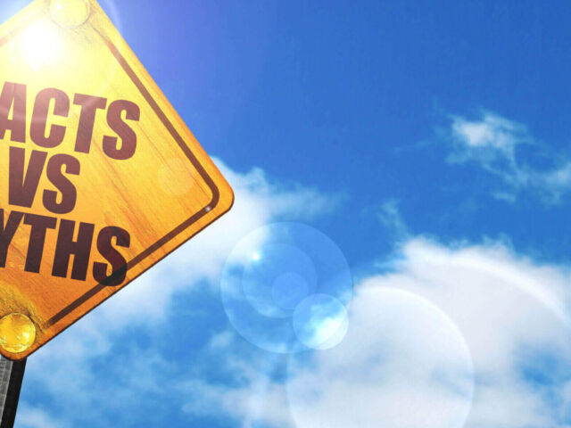Yellow road sign with a blue sky and white clouds: facts vs myth