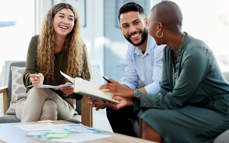 Happy business people smile during a planning meeting in a startup marketing agency office. Diversity, collaboration and teamwork in a healthy work environment in an international advertising company.