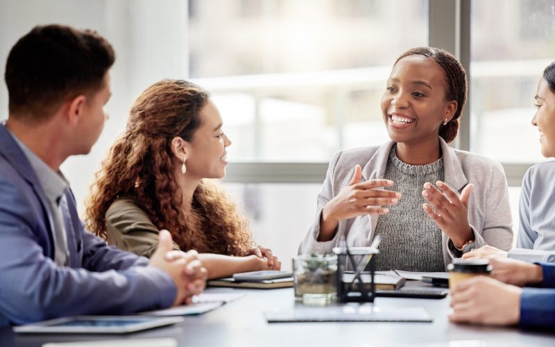 Discussion, meeting and business people in office for teamwork, planning or review at table. Collaboration, professional and group of diverse employees for ideas, conversation or project development.